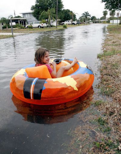 
Tori Reece, 6, floats in front of her home in Dunedin, Fla., on Saturday after Tropical Storm Barry flooded the streets.  Barry weakened into a tropical depression as it moved through the state. 
 (Associated Press / The Spokesman-Review)