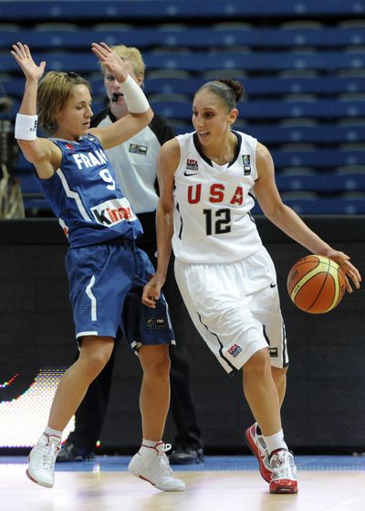 Diana Taurasi, right, of the United States, runs by a France defender in a World Basketball Championship preliminary.  (Associated Press)