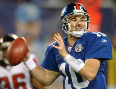 
Giants quarterback Eli Manning looks for a receiver during the second quarter against the Falcons on Sunday.
 (Associated Press / The Spokesman-Review)