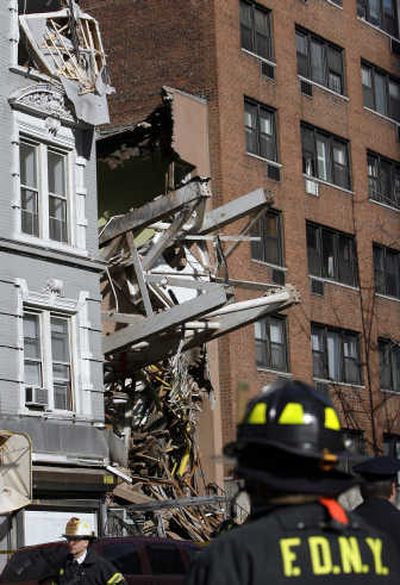 
A section of collapsed crane protrudes from a crushed building on in New York City on Saturday. Associated Press
 (Associated Press / The Spokesman-Review)