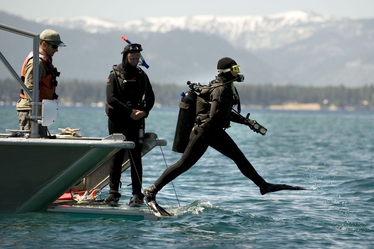 Research scientist Brant Allen steps off a dive boat into  Lake Tahoe on Friday.  (Associated Press)