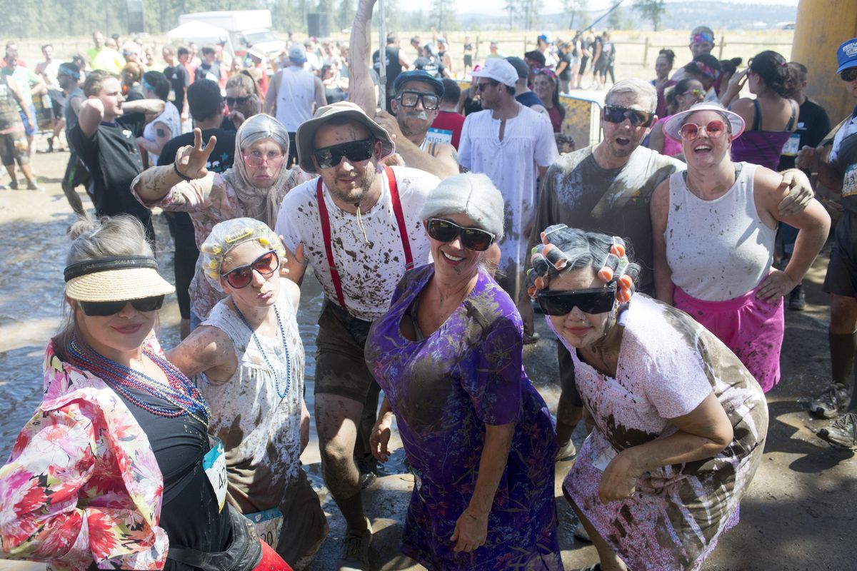 A group from the Tri Cities dressed up for their turn through the Dirty Dash race course Saturday, July 8, 2017 at Riverside State Park. The popular foot race takes contestants through mud bogs and over obstacles. (Jesse Tinsley / The Spokesman-Review)
