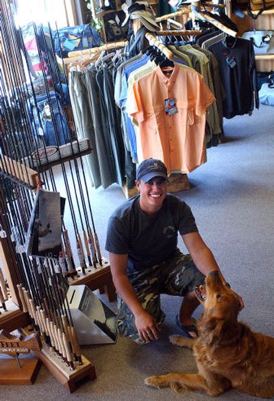 
Silver Bow Fly Shop owner Sean Visintainer hangs out in his store  with his dog, Tripod. Last Labor Day, Visintainer moved his shop from Liberty Lake to its current location, 13210 E. Indiana Ave.
 (Liz Kishimoto / The Spokesman-Review)