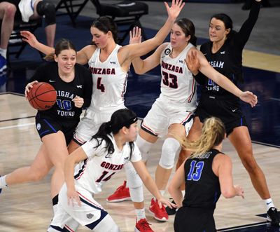 Gonzaga forward LeeAnne Wirth (4) and Gonzaga forward Melody Kempton (33) try to keep BYU guard Tegan Graham (10) out of the key during the second half of an NCAA college basketball game, Tuesday, Feb. 2, 2021, in the McCarthey Athletic Center.  (Colin Mulvany/THE SPOKESMAN-REVIEW)