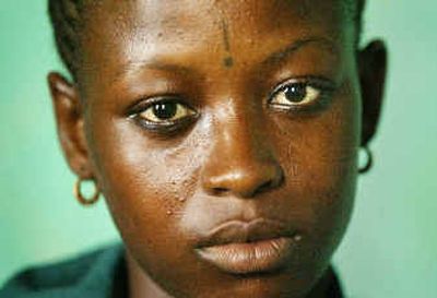 
At age 8, Mamoussa Bangura, now 19, witnessed the killing of her family. She was abducted and raped for years by a rebel fighter and had an exclamation mark burned into her forehead as a sign of possession. 
 (Associated Press / The Spokesman-Review)
