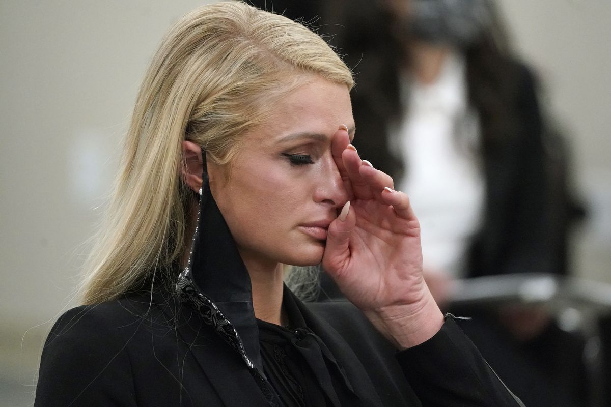 Paris Hilton wipes her eyes after speaking at a committee hearing at the Utah State Capitol, Monday, Feb. 8, 2021, in Salt Lake City. Hilton has been speaking out about abuse she says she suffered at a boarding school in Utah in the 1990s and she testified in front of state lawmakers weighing new regulations for the industry.  (Rick Bowmer)
