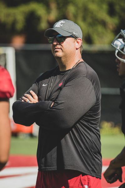 Washington State offensive coordinator Brian Smith watches over practice at the Cougars’ preseason camp.  (Courtesy WSU Athletics)