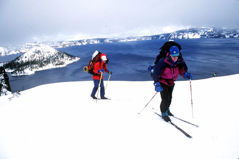 Backcountry skiers circumnavigate Crater Lake in Oregon during normal winter snow levels.
 (Rich Landers)
