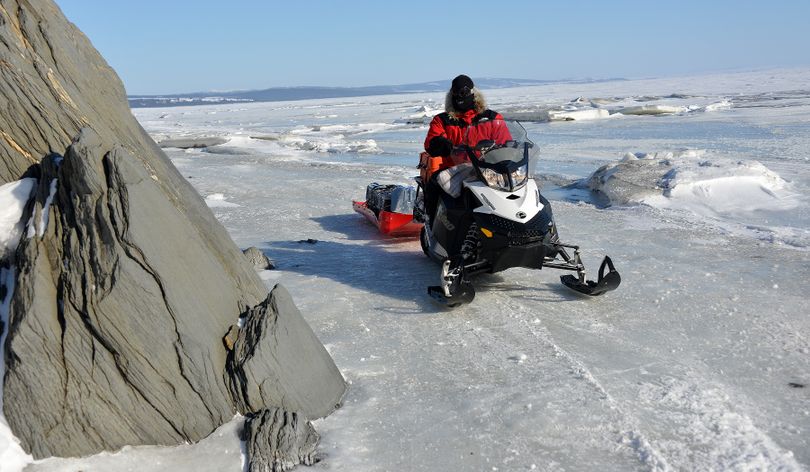 Josh Rindal on the Iditarod Trail between Elim and Koyuk coming south.  This section went out onto the sea ice for a few miles, where it made it's way between some unusual rock formations along the land and some unusual broken-ice conditions on the sea. Rindal and Bob Jones of Kettle Falls were snowmobiling 1,400-miles along the route of Alaska's famous Iditarod Sled Dog Race in March 2014. (Robert Jones)