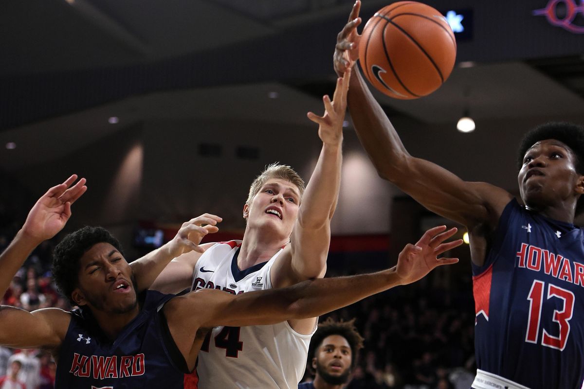 Gonzaga center Jacob Larsen (14) competes for a rebound withe Howard forward Marcus Hall (5) and Howard forward Charles Williams (13) during the first half of a college basketball game, Tues. Nov. 14, 2017, in the McCarthey Athletic Center. (Colin Mulvany / The Spokesman-Review)