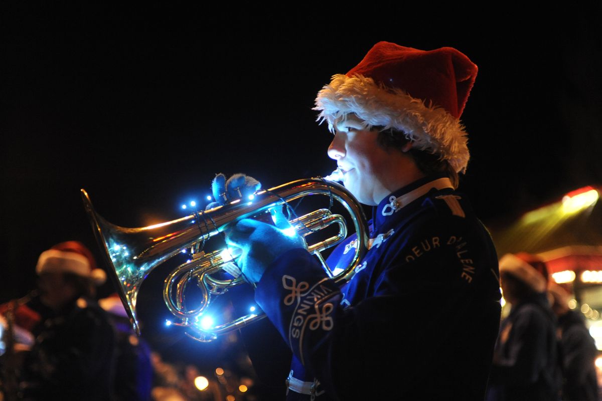 Tommy Enders plays the mellophone in the Coeur d’Alene High School marching band as he participates in the annual holiday parade through downtown Coeur d’Alene. (Jesse Tinsley)