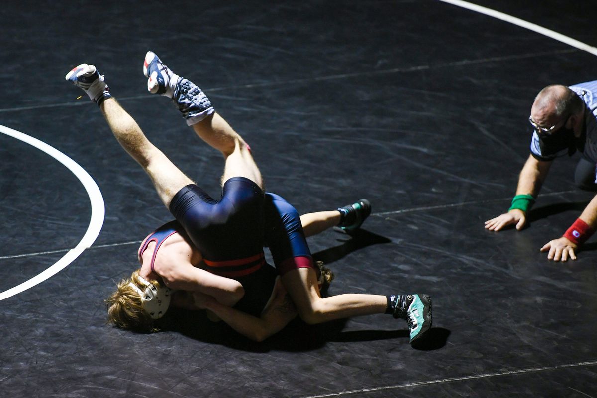 Mt. Spokane wrestler Nolan Crosby, left, upends North Central