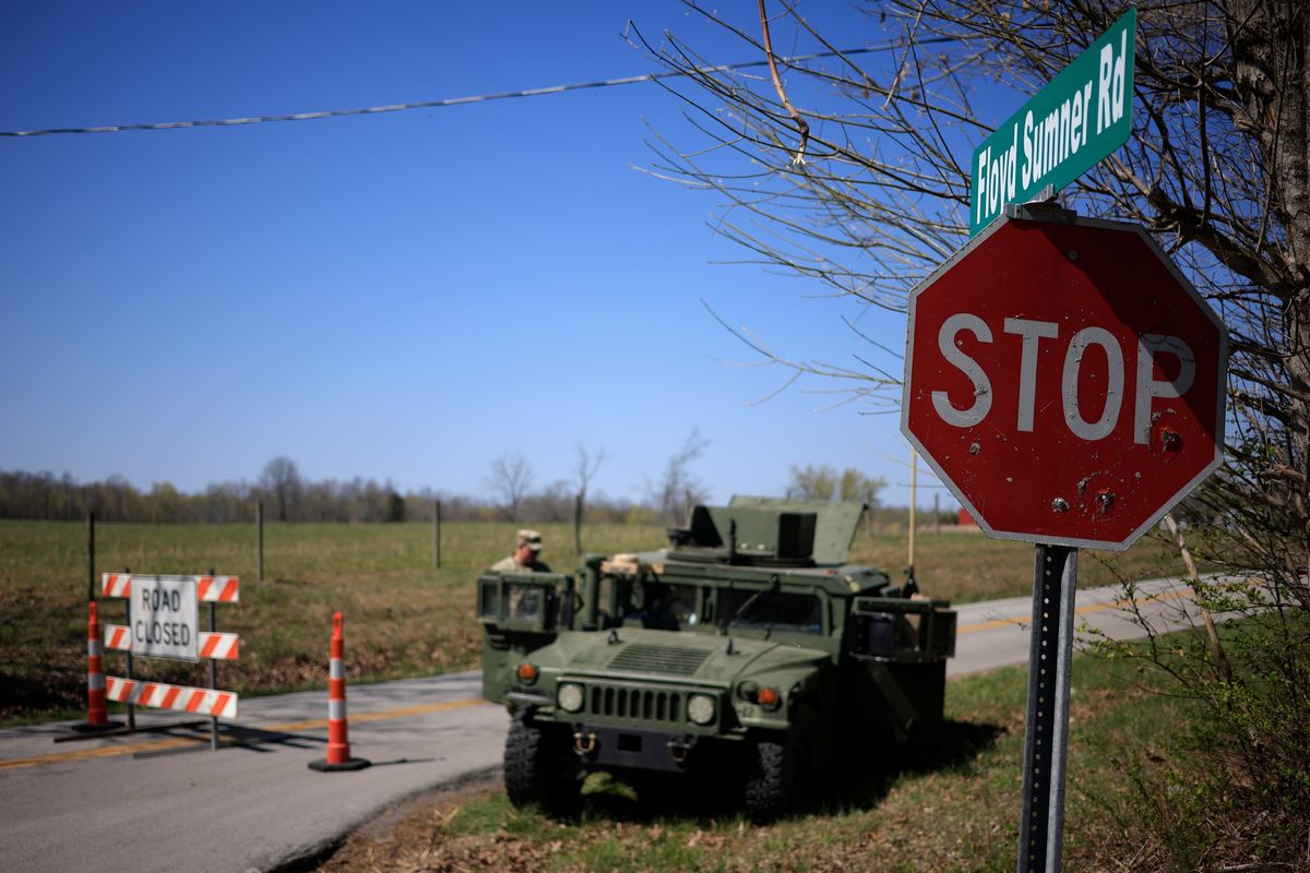A Humvee from the U.S. Armys 101st Airborne Division sits parked at a checkpoint near the site where two UH-60 Blackhawk helicopters crashed on Thursday in Cadiz, Ky. Nine soldiers based at Fort Campbell were killed in the incident that occurred during a night training mission.  (Luke Sharrett)