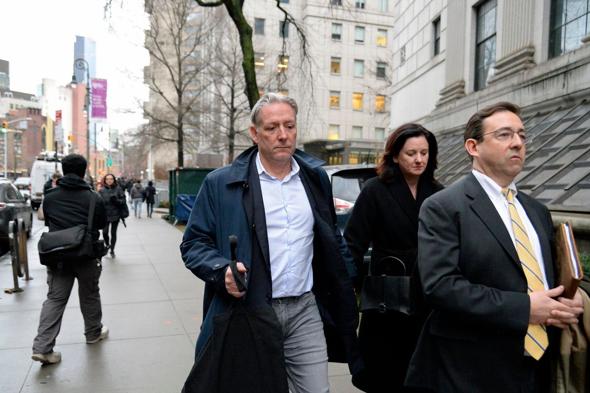 Charles McGonigal, center, leaves Federal District court in Manhattan after his arrest and arraignment on Jan. 23.  (JEFFERSON SIEGEL)