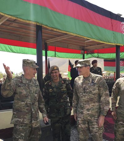 U.S. Gen. John Nicholson, top U.S. commander in Afghanistan, left, talks with Col. Khanullah Shuja, commander of the national mission brigade of the Afghan special operations force, and U.S. Gen. Joseph Votel, head of U.S. Central Command, at Camp Morehead in Afghanistan on Sunday, Aug. 20, 2017. (Lolita Baldor / Associated Press)