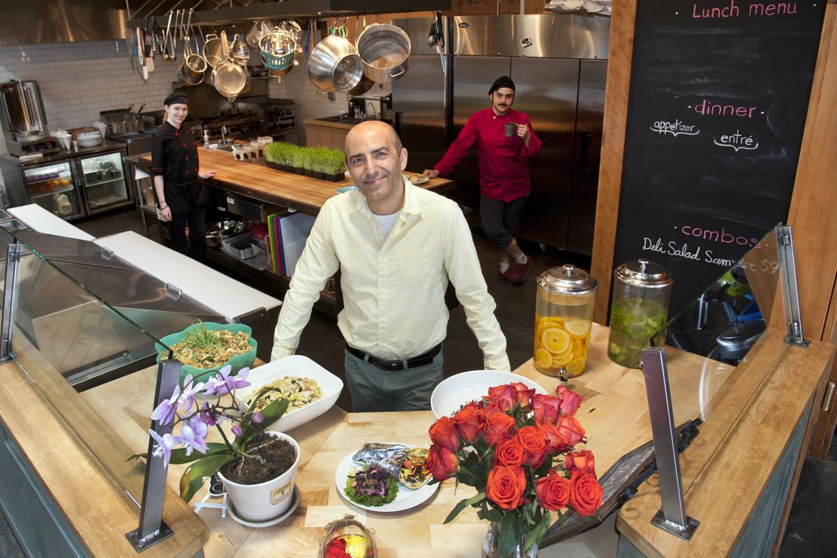 Proprietor Shahrokh “Sharo” Nikfar, center, stands behind the counter at Mediterrano, along with chef Merry Migliuri, left, and sous chef David Jones. (Dan Pelle)