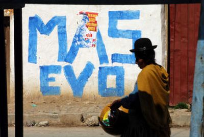 An indigenous woman walks past a wall with graffiti that shows support of presidential candidate Evo Morales on Saturday in La Paz, Bolivia.
(Associated Press / The Spokesman-Review)