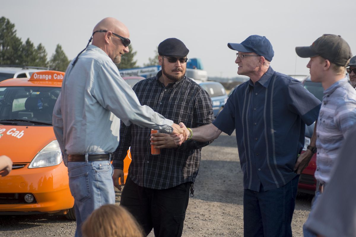 Taxi drivers, from left, Ron Diltz, Andrew Caudell and Jerry Matheson, along with Matheson’s son Colton Matheson, right, great each other as cabbies gathered Saturday morning at Spokane International Airport for a procession from the airport to Hennessy Funeral Home on Pines in Spokane Valley on Saturday, Sept. 2, 2017. The procession was in honor of Gagandeep “Dagger” Singh, who was murdered while driving a fare through Bonner County, Idaho recently. (Jesse Tinsley / The Spokesman-Review)