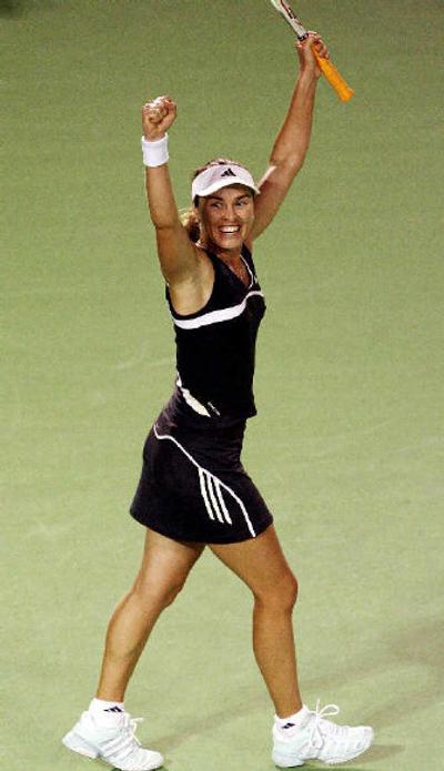 
Martina Hingis raises her arms in celebration upon earning a spot in the quarterfinals. 
 (Associated Press / The Spokesman-Review)