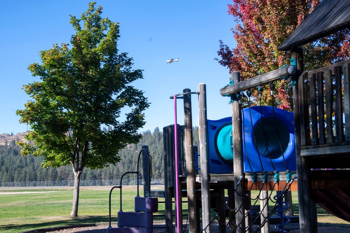 An airplane on final approach to Felts Field passes near the play structure on Thursday at Orchard Park near Felts Field.  (Jesse Tinsley/The Spokesman-Review)