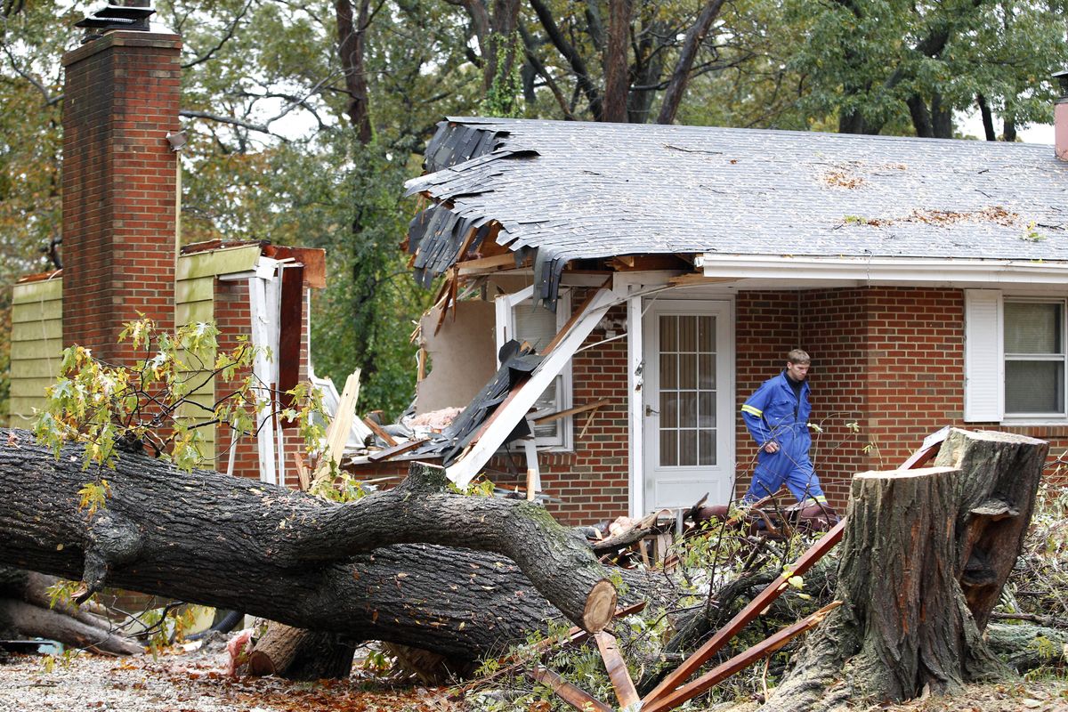 FILE - In this Tuesday, Oct. 30, 2012 file photo, a firefighter leaves the destroyed home in Pasadena, Md where Donald Cannata Sr. was killed overnight when a tree fell on it during superstorm Sandy. (Jose Magana / Fr159526 Ap)