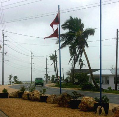
Hurricane watch flags flutter with the winds from the outer bands of Hurricane Wilma at the eastern shoreline of Grand Cayman Island Tuesday. 
 (Associated Press / The Spokesman-Review)