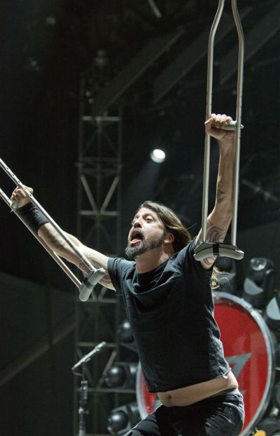 Down but not out: Foo Fighters frontman Dave Grohl takes the stage Friday night with his crutches aloft at the Gentlemen of the Road Stopover festival in Walla Walla. Grohl fell onstage in Sweden in June and fractured his foot, but he had a cast put on his leg during that show and finished the performance. The Walla Walla festival continued Saturday with headliners Mumford and Sons. (Greg Lehman)