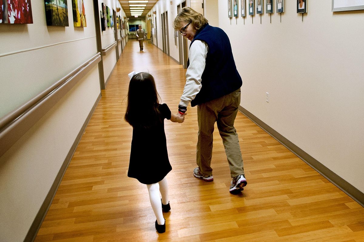 Jenna Roberts, 4, walks with Barb Wellman, occupational therapist at Kootenai Health Rehabilitation Services in Coeur d’Alene on Nov.1. (Kathy Plonka / The Spokesman-Review)