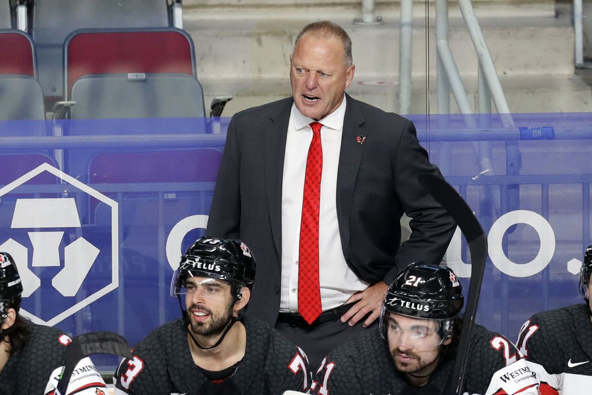 In this June 5, 2021 photo, Canada head coach Gerard Gallant, top, stands behind his bench during the Ice Hockey World Championship semifinal match against the United States in Riga, Latvia. The New York Rangers have reached an agreement to hire Gallant as their next coach, a person with knowledge of the move tells The Associated Press.  (Sergei Grits)