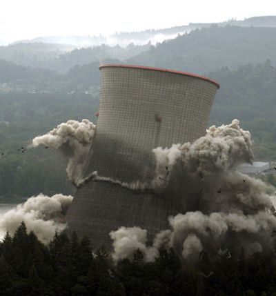 
The cooling tower of the decommissioned Trojan nuclear power plant collapses  on itself in a cloud of dust and flying debris as it was imploded Sunday near Rainier, Ore. 
 (Associated Press / The Spokesman-Review)