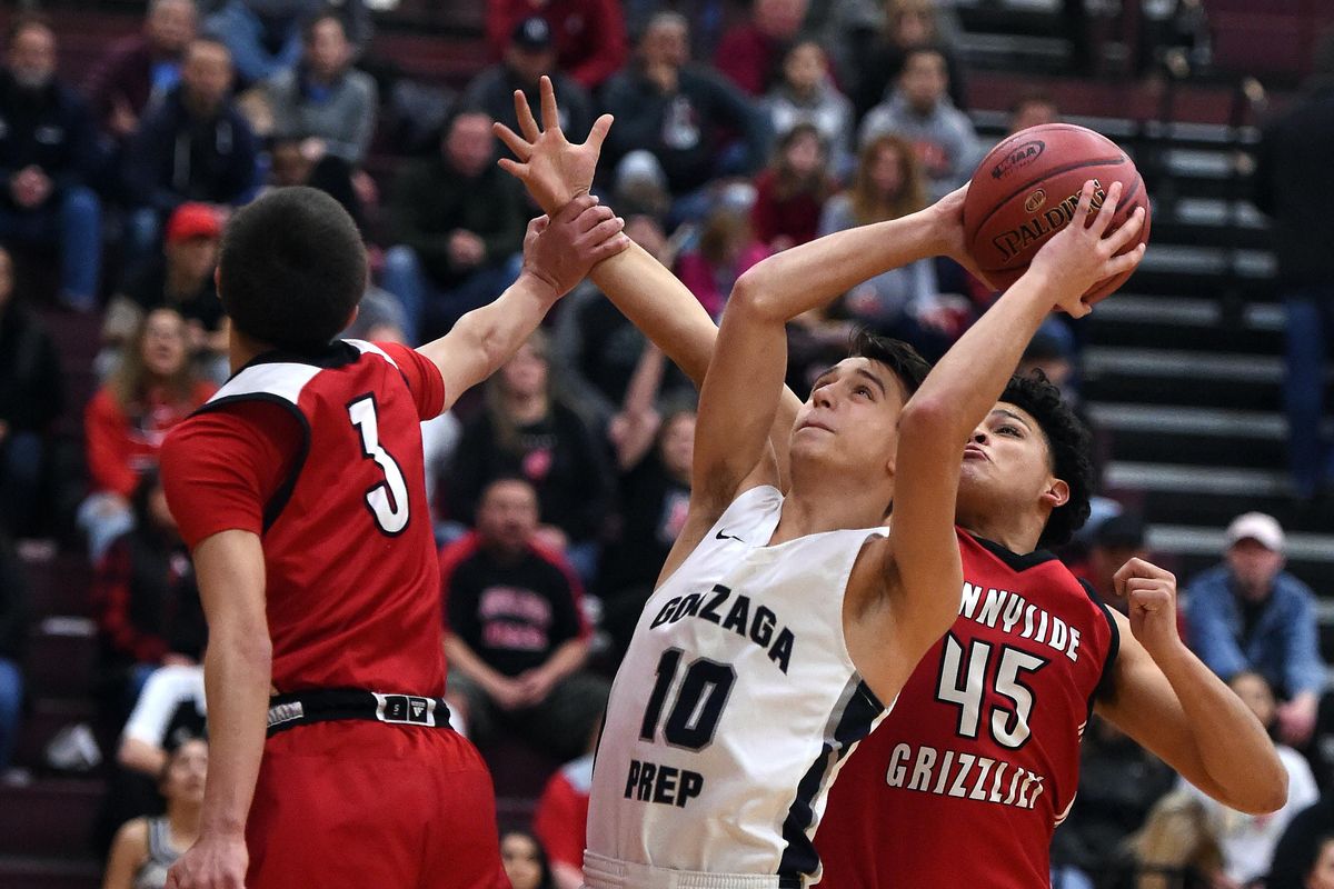 Gonzaga Prep’s Jacob Parola (10) heads to the basket for a layup as Sunnyside’s Art Salacious (3) and Ismael Zavala (45) defend during the first half of a WIAA 4A regional playoff basketball game, Friday, Feb. 23, 2018, at University High School. Parola has developed into a tough defensive player on the court. (Colin Mulvany / The Spokesman-Review)