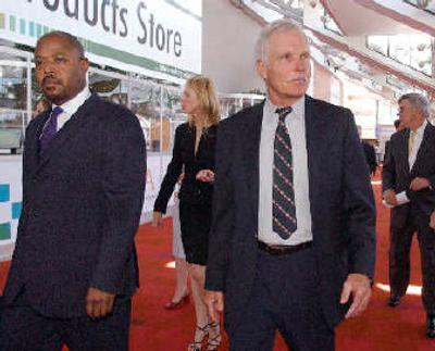 
Ted Turner, right, is flanked by Turner spokesman Philip Evans as he arrives for the annual Time Warner Inc., shareholders meeting at the Georgia World Congress Center, in Atlanta. 
 (Associated Press / The Spokesman-Review)