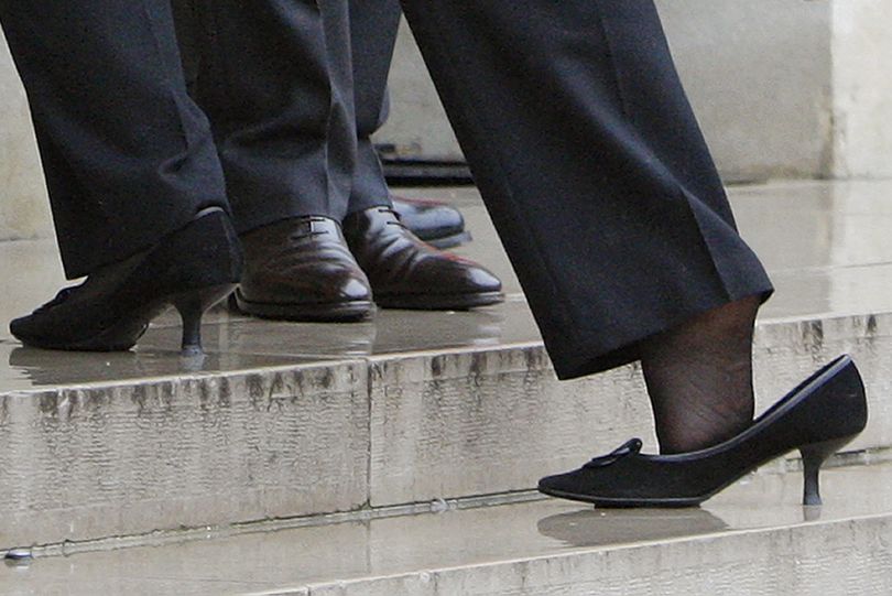 ** ALTERNATIVE CROP FROM ENA101 ** U.S. Secretary of State Hillary Rodham Clinton, foreground, loses her shoe as she is greeted by French President Nicolas Sarkozy on the steps of the Elysee palace upon her arrival Friday, Jan. 29, 2010,  in Paris.  Clinton flew to Paris on Friday for talks with French officials and to give a speech on European security. (Christophe Ena / Associated Press)