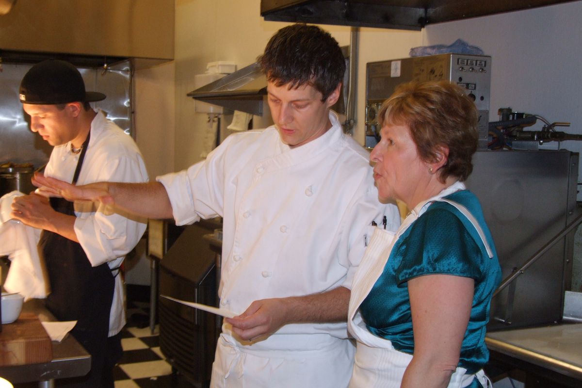 Jeremy Hansen, owner of Sante, helps orient Sen. Lisa Brown with the kitchen of the Spokane-area restaurant during a wine event. Hansen said Sante likes to help educate the community on local food. (Paul K. Haeder  / Down to Earth NW Correspondent)