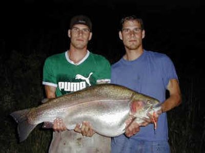 
Saskatchewan angler Adam Konrad, left, poses with twin brother Sean and the pending world record 43.6-pound rainbow trout from Lake Defienbaker. Photo courtesy of TrophyTroutGuide.com
 (Photo courtesy of TrophyTroutGuide.com / The Spokesman-Review)