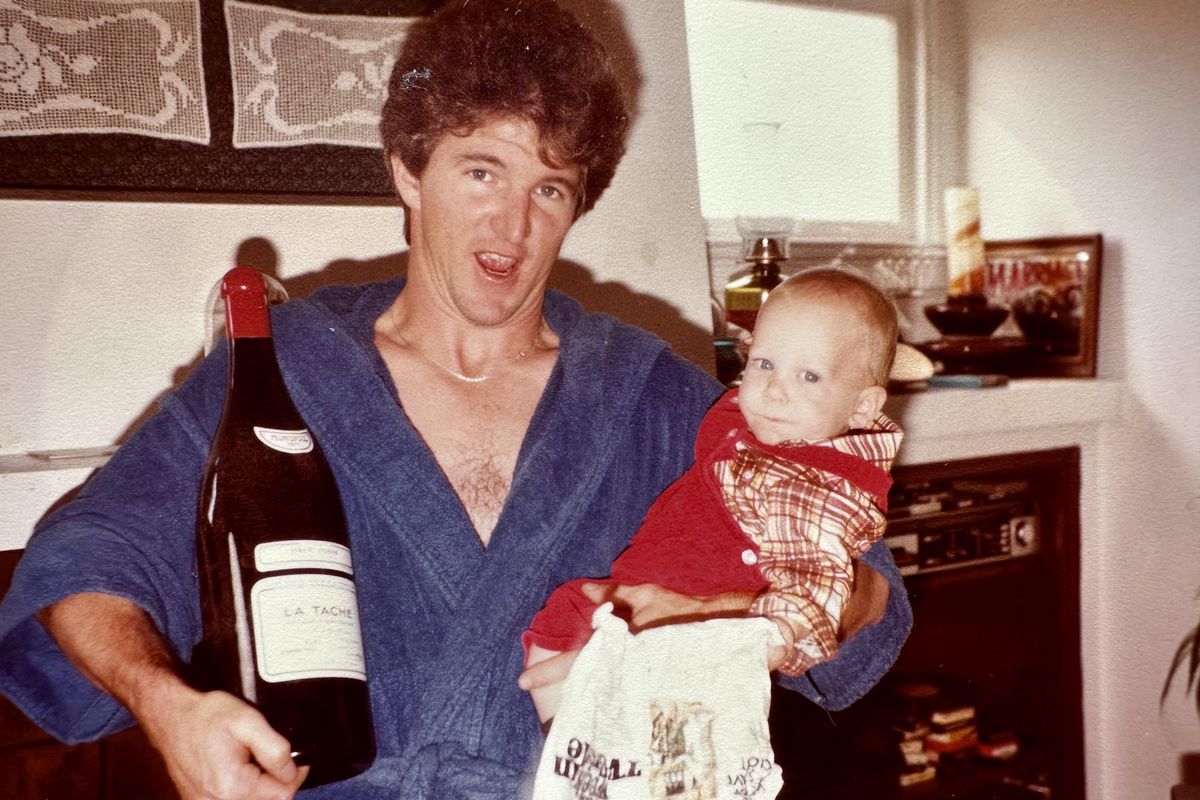 Mark Paulson holds his nephew and a bottle of 1971 Domaine de la Romanée-Conti La Tâche, which he bought for $250 in the late 1970s. MUST CREDIT: Family photo courtesy of Bonhams Skinner  (Family photo/Handout)