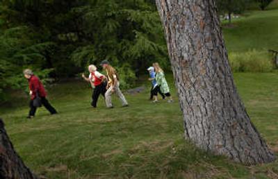
Sally Reynolds, left, of Spokane, leads board members of the National Association of Olmsted Parks on a tour of Finch Arboretum on Thursday. 
 (Brian Plonka / The Spokesman-Review)