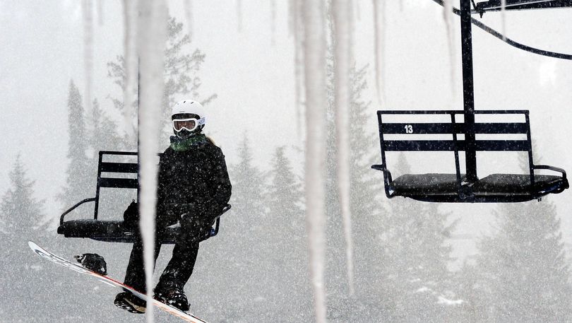 A snowboarder hits the lifts at Schweitzer Mountain on Wednesday, taking advantage of the spring snow that hit the Inland Northwest. (Kathy Plonka)