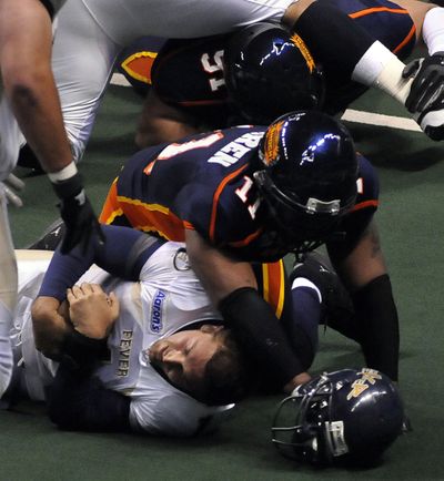 Spokane’s Justin Warren lowers the boom on Tri-Cities QB Joe Ayoob in the first quarter. (Dan Pelle / The Spokesman-Review)