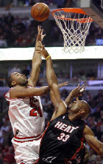 
Chicago's Othella Harrington, left, shoots over Miami's Alonzo Mourning during the second quarter Thursday. 
 (Associated Press / The Spokesman-Review)
