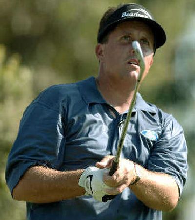 
Golfer Phil Mickelson watches his tee shot on the fourth hole during the Battle at the Bridges.
 (Associated Press / The Spokesman-Review)