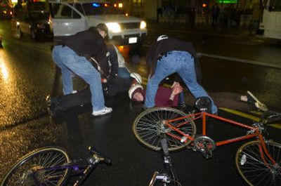 
Bicyclists who participated in a Critical Mass demonstration in downtown Spokane are handcuffed by police on Friday evening. 
 (Colin Mulvany / The Spokesman-Review)