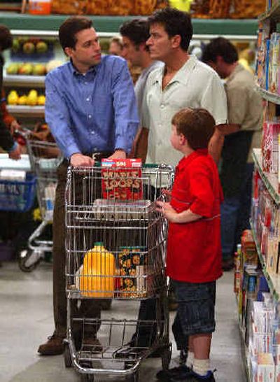 
Jon Cryer, left, Charlie Sheen and Angus T. Jones appear in CBS' 