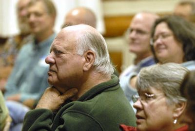 
Fields Cobb sits in the crowd and listens intently to the presentation by a group of scientists talking about global warming Saturday at Sandpoint.  
 (photo by JESSE TINSLEY / The Spokesman-Review)