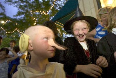 
Dylan Blair, 6, dressed as Dobby the house elf, and his sister, Holly Thomason, 9, dressed as Professor McGonagal, line up in front of Auntie's Bookstore Friday night. 
 (Colin Mulvany / The Spokesman-Review)