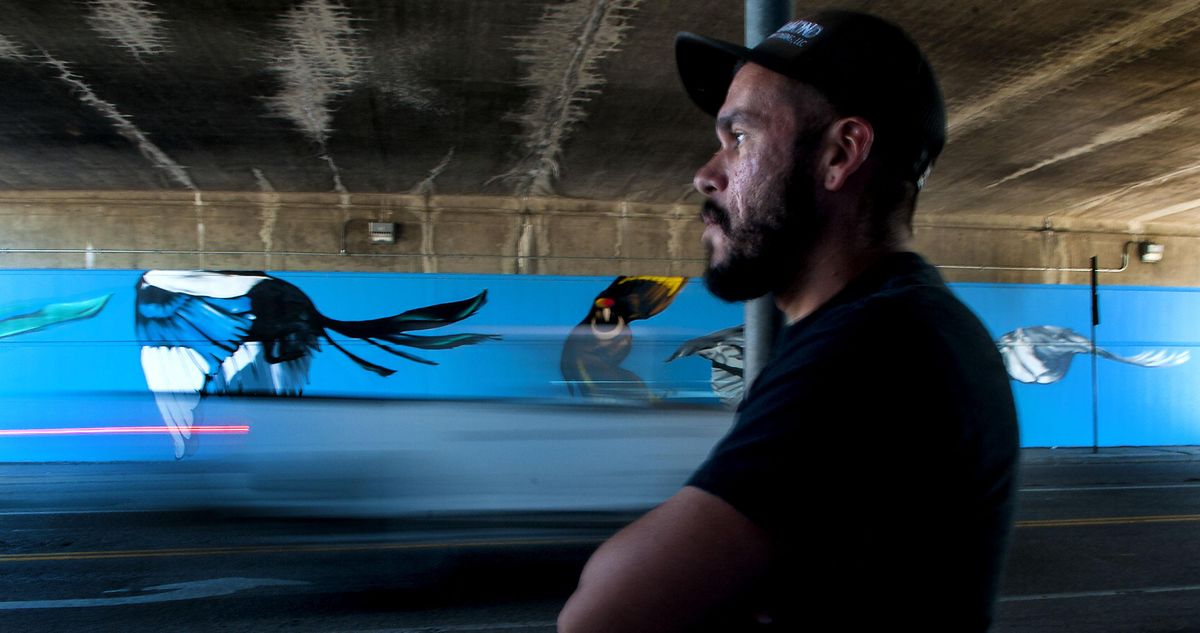 Artist Daniel Lopez talks about his completed work on a mural under the Altamont Street and Interstate 90  overpass on Wednesday, Sept. 27, 2017. (Kathy Plonka / The Spokesman-Review)