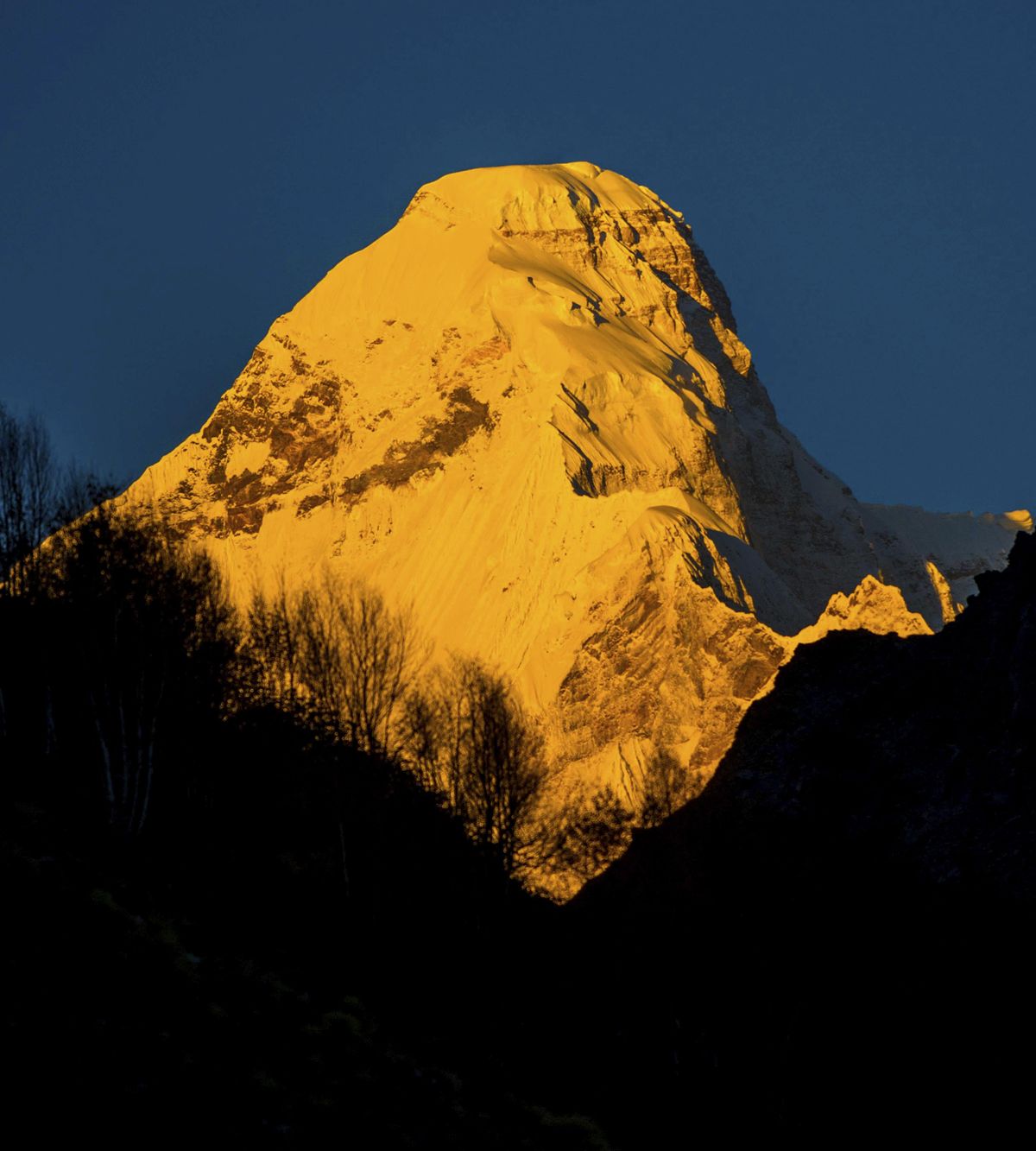 In this Oct. 8, 2016, photograph provided by Juniper Outdoor Pursuits Centre Pvt. Ltd., shows early morning light falling on Nanda Devi east base peak, seen from Pachu valley in Uttarakhand, India. Indian air force pilots have resumed a search over a Himalayan mountain for a team of mostly foreign climbers missing since late May. The fourth day of the search on Tuesday was taking place in the northern state of Uttarakhand after five bodies were spotted in the snow in high-resolution photos taken Monday. (Maninder Kohli / AP)