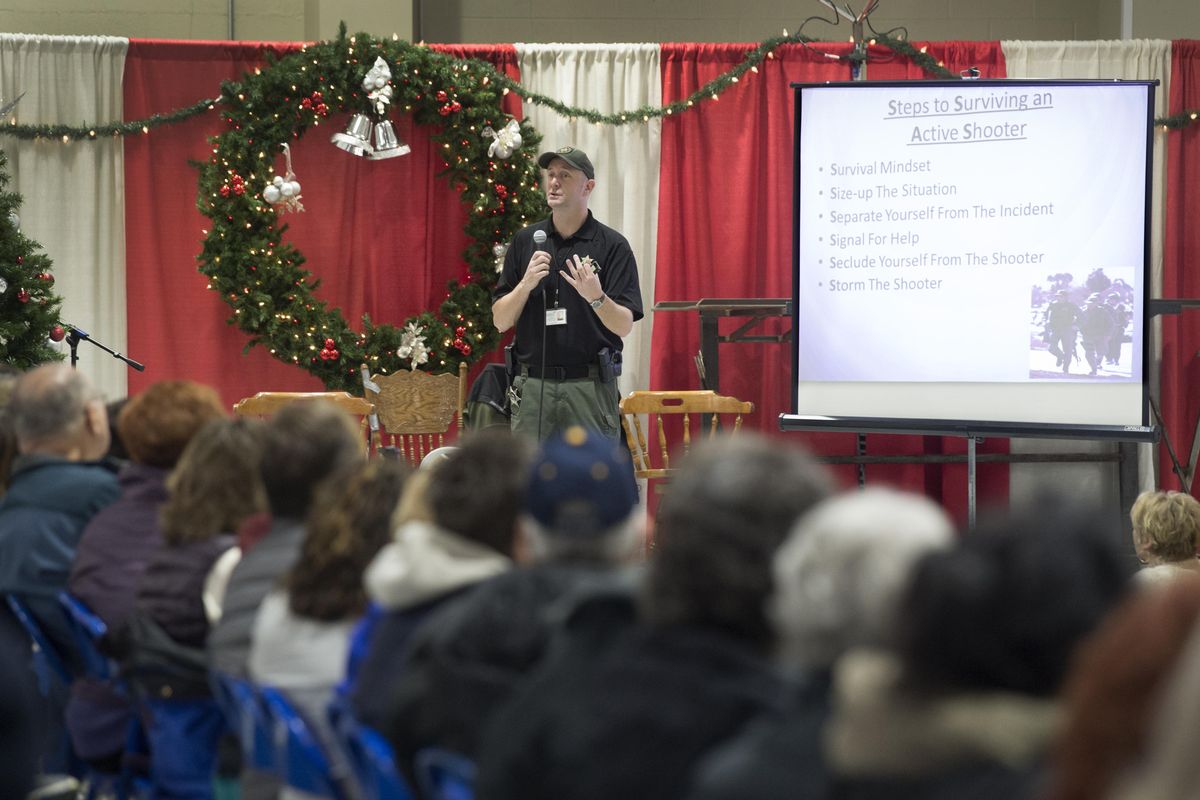 Spokane County Deputy Chris Johnston gives and talk, and showed a video, about surviving an active shooter situation, part of the training that the Christmas Bureau volunteers went through Thursday, Dec. 7, 2017 at the Spokane County Fair and Expo Center. (Jesse Tinsley / The Spokesman-Review)