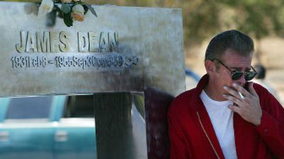 
James Dean impersonator Scott Brimigion (stage name Scott Brim), of Valencia, Calif., poses next to the James Dean memorial at the Jack Ranch Cafe in Cholame, Calif., on Friday, 50 years after Dean's death.  
 (Associated Press / The Spokesman-Review)