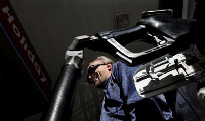 “I’m real happy about $3 gas,” said Mike Ziegwied, as he filled his tank at Holiday gas station in Coeur d’Alene on Tuesday. Ziegwied works for North Country Transportation, a non-emergency medical transportation service out of Bonners Ferry, Idaho.  (Kathy Plonka / The Spokesman-Review)